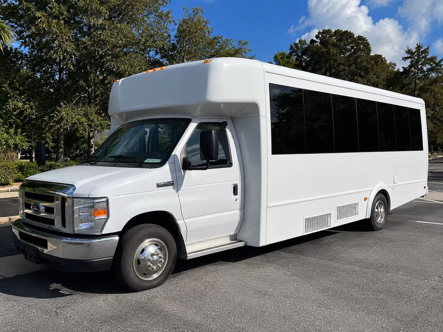Group beside a Mercedes Sprinter limo in Cary